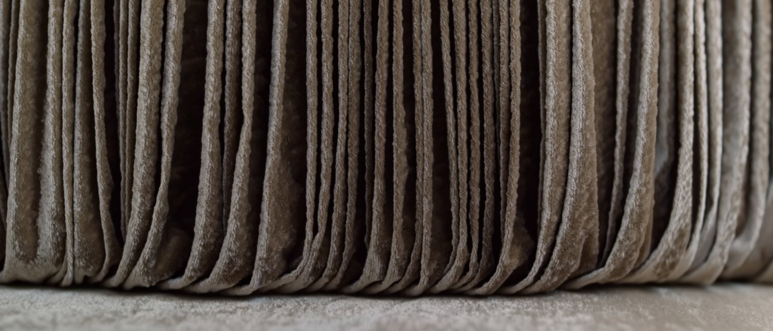 a stage curtain of heavy velvet, drawn closed and lit from its own side