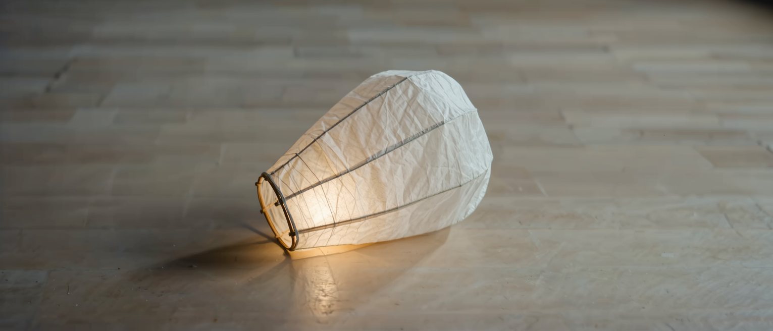a paper lantern lit from within, its frame showing faintly through the skin