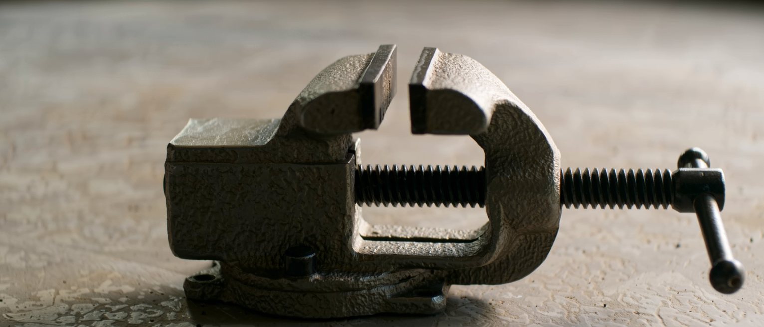 a bench vice wound almost closed, the jaws nearly meeting