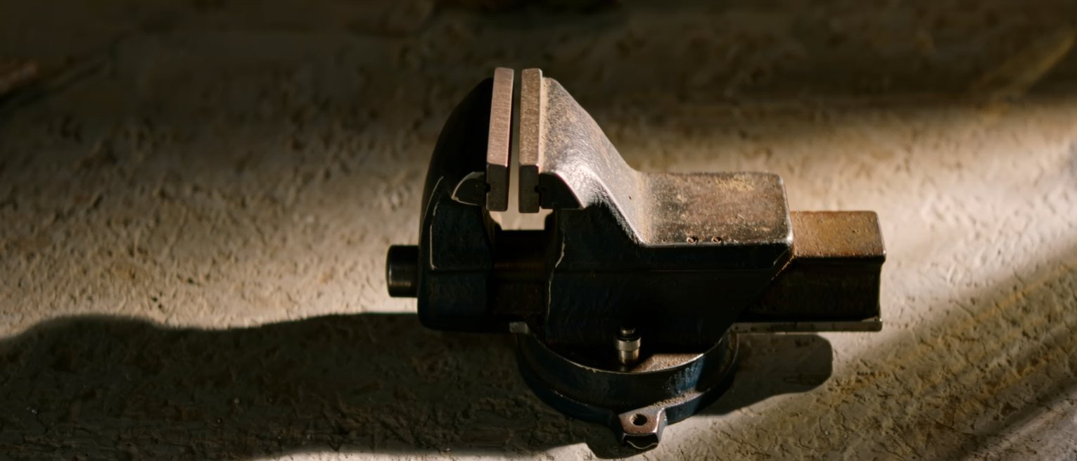 a bench vice wound almost closed, the jaws nearly meeting