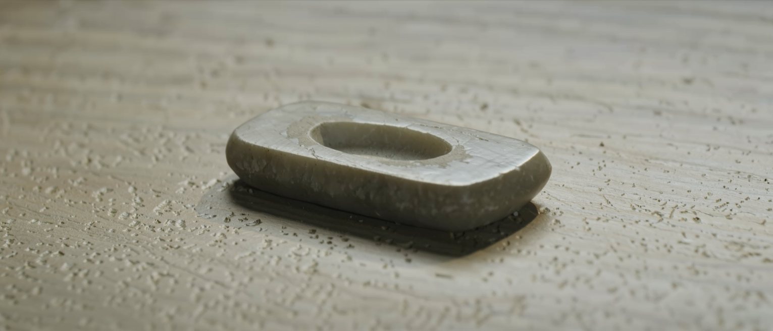 a whetstone worn hollow in the middle from years of the same stroke