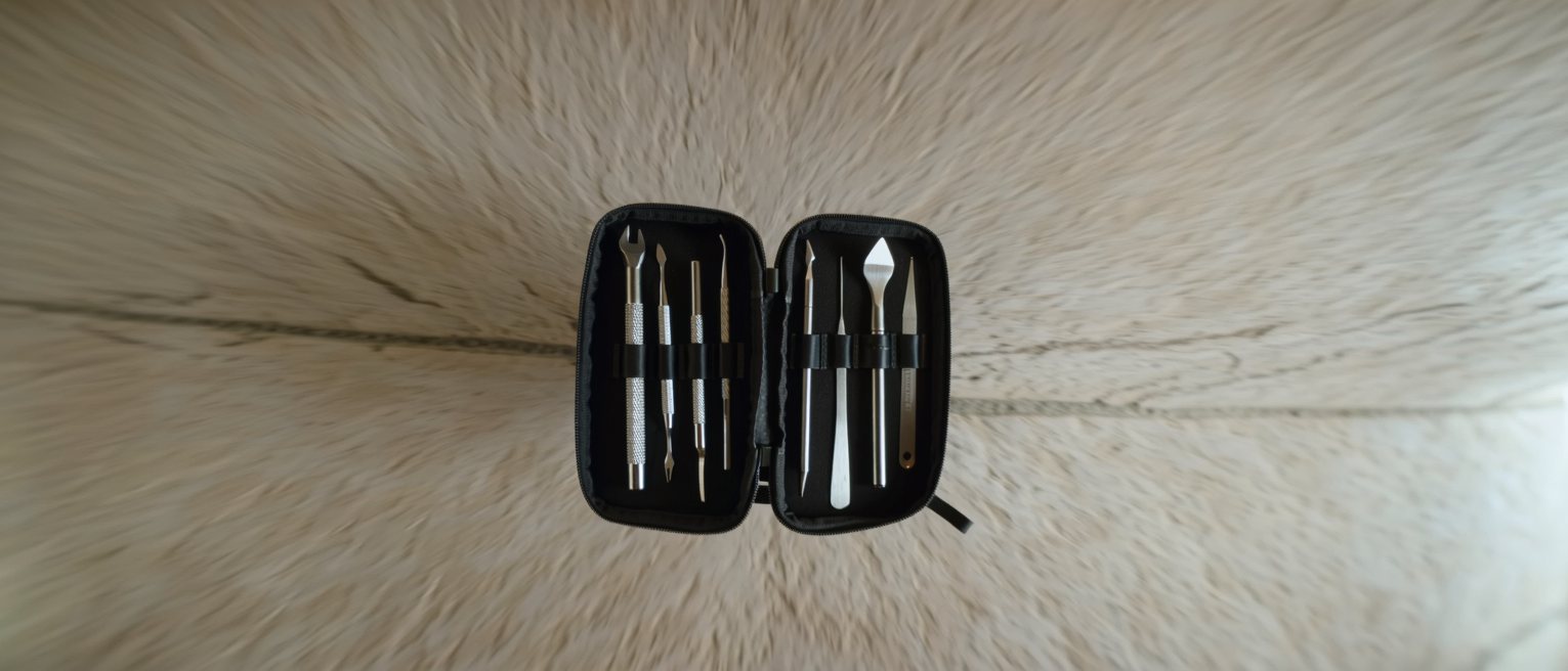 a set of clean tools laid back into their fitted case on a workbench, each one seated in its own recess