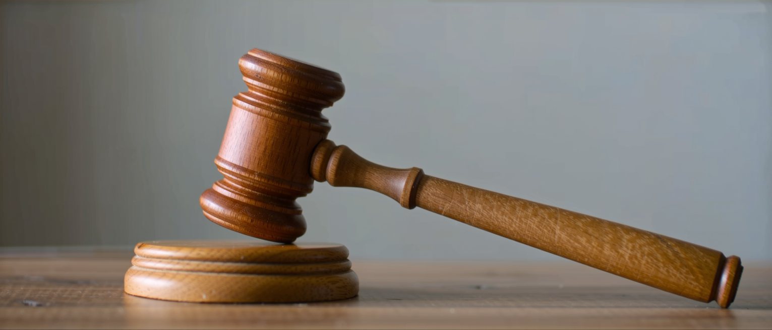 a wooden auctioneer's gavel resting on its striking block