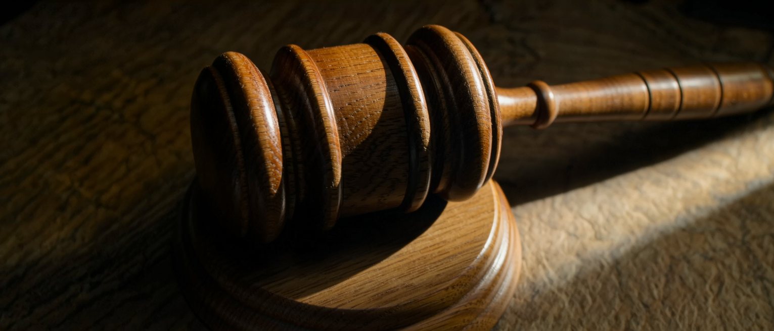 a wooden auctioneer's gavel resting on its striking block