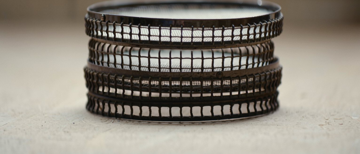 a set of graded sieves stacked one inside another, the meshes finer toward the bottom