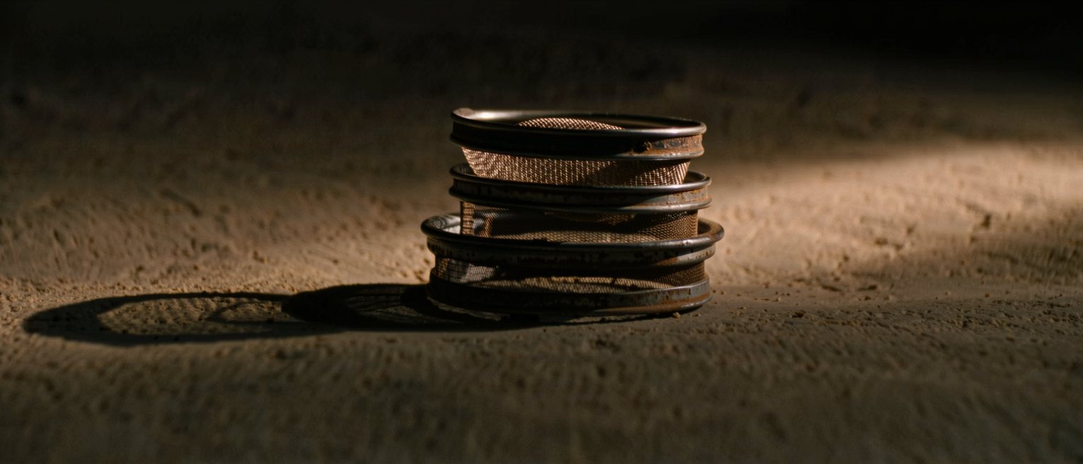 a set of graded sieves stacked one inside another, the meshes finer toward the bottom