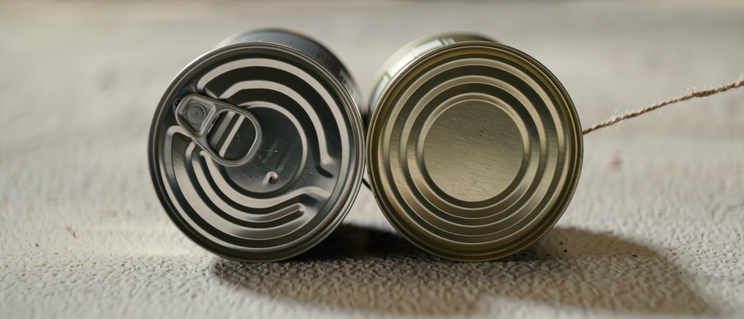 two tin cans joined by a waxed string pulled taut between them