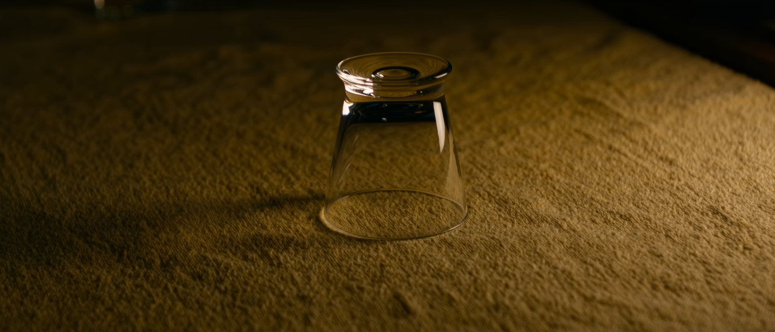 a clean drinking glass turned upside down on a bar towel, no ring left beneath it
