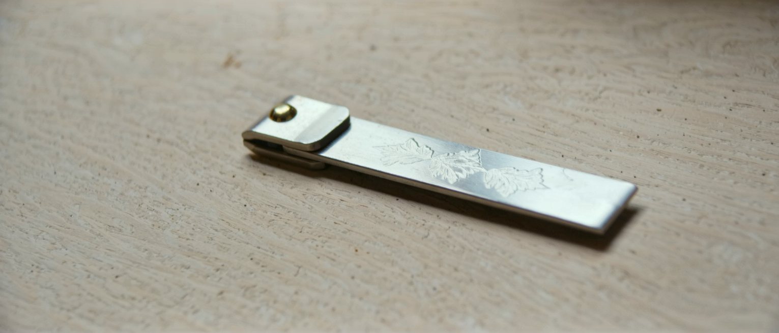 a folding boxwood carpenter's rule opened out to its full length and lying straight across the frame