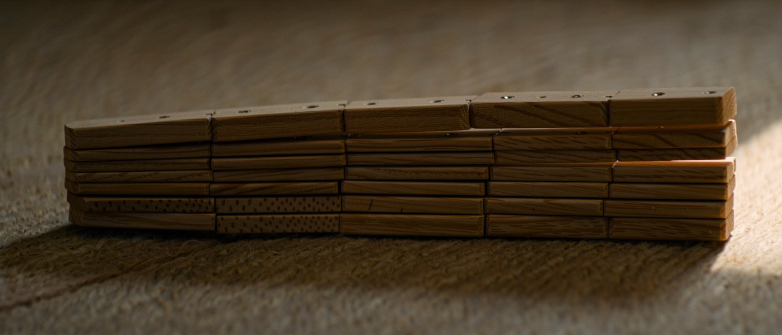 a folding boxwood carpenter's rule opened out to its full length and lying straight across the frame
