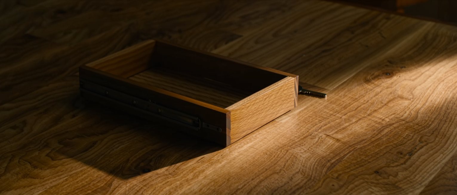a well-made wooden drawer stopped an inch short of closing, the runner clean and the fit tight
