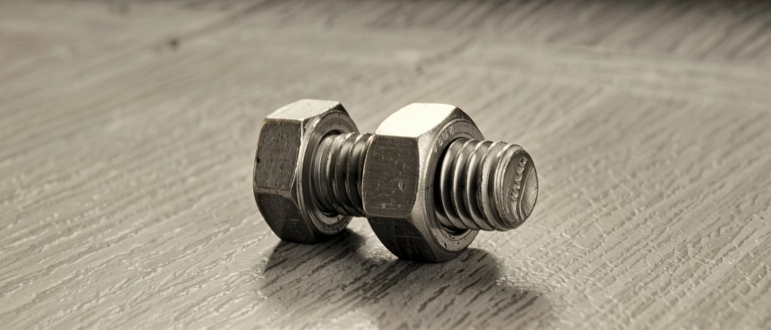 a steel bolt run into a nut of a different thread pitch, tight for two turns and then binding