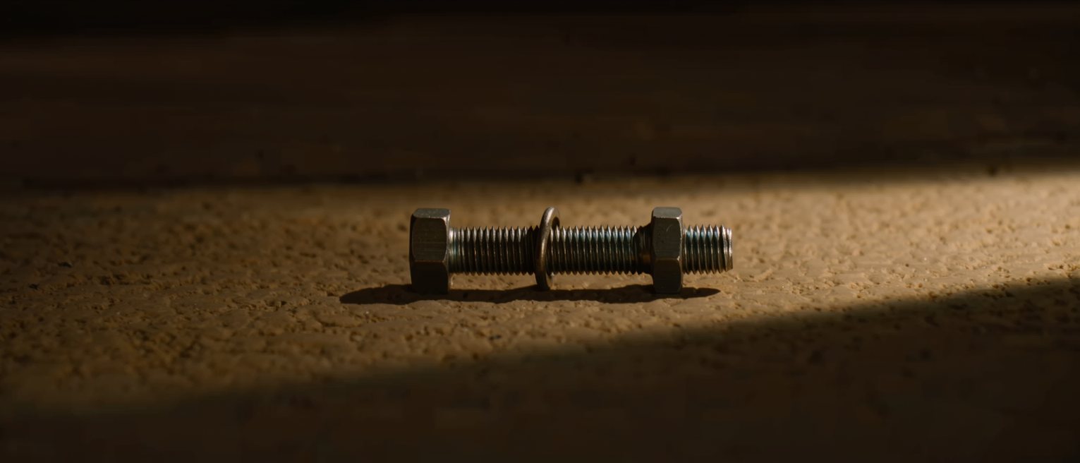 a steel bolt run into a nut of a different thread pitch, tight for two turns and then binding