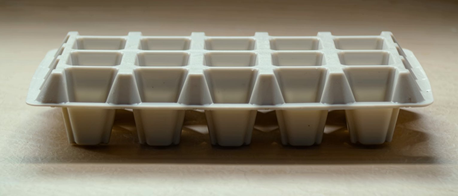 a moulded plastic tray of identical compartments, every one the same size and depth