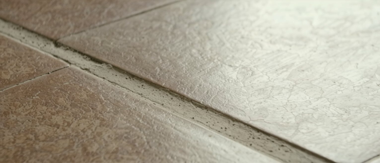 floor tiles worn into a pale path by one route walked over and over
