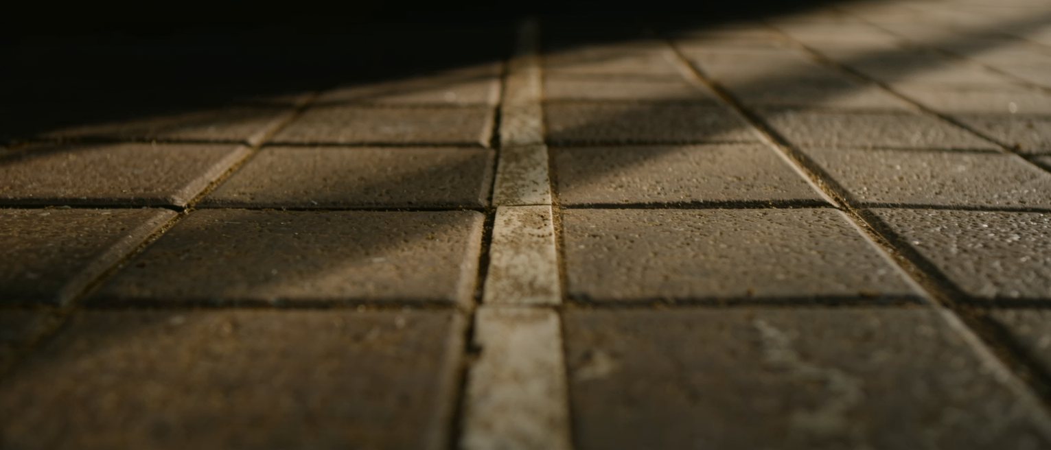 floor tiles worn into a pale path by one route walked over and over
