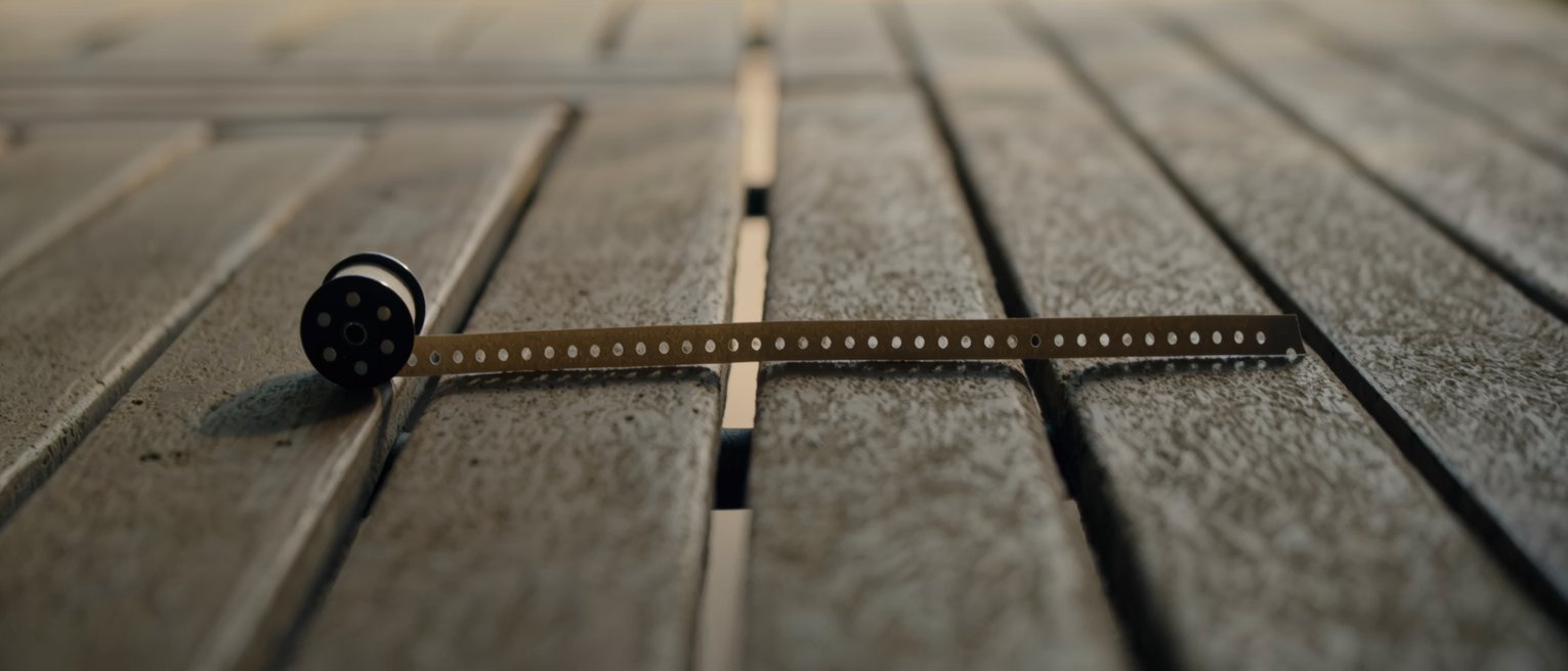 a long strip of blank paper tickets folded into a concertina stack on a bench, every ticket identical and unprinted