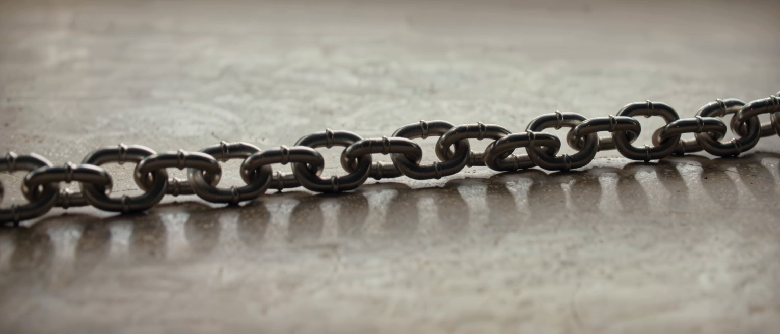 a steel chain running out of frame at both ends, every link the same