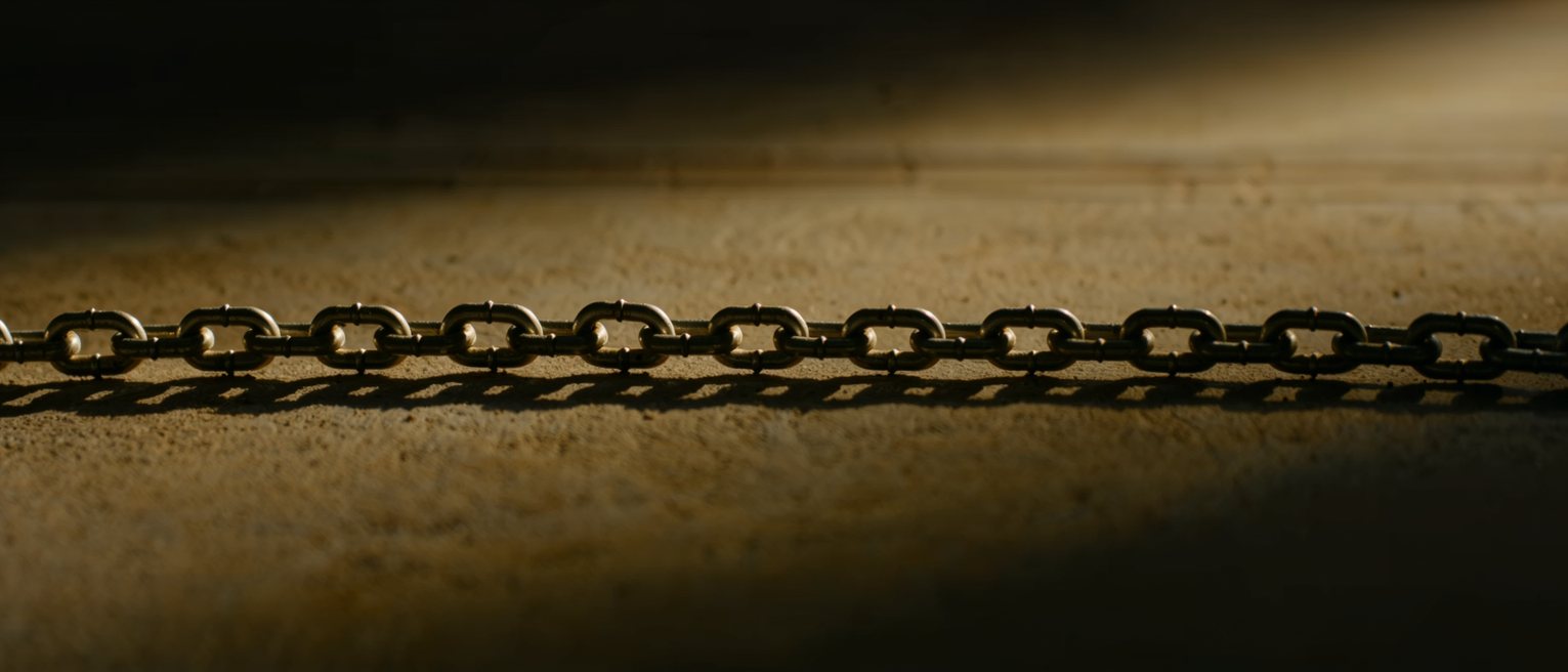a steel chain running out of frame at both ends, every link the same