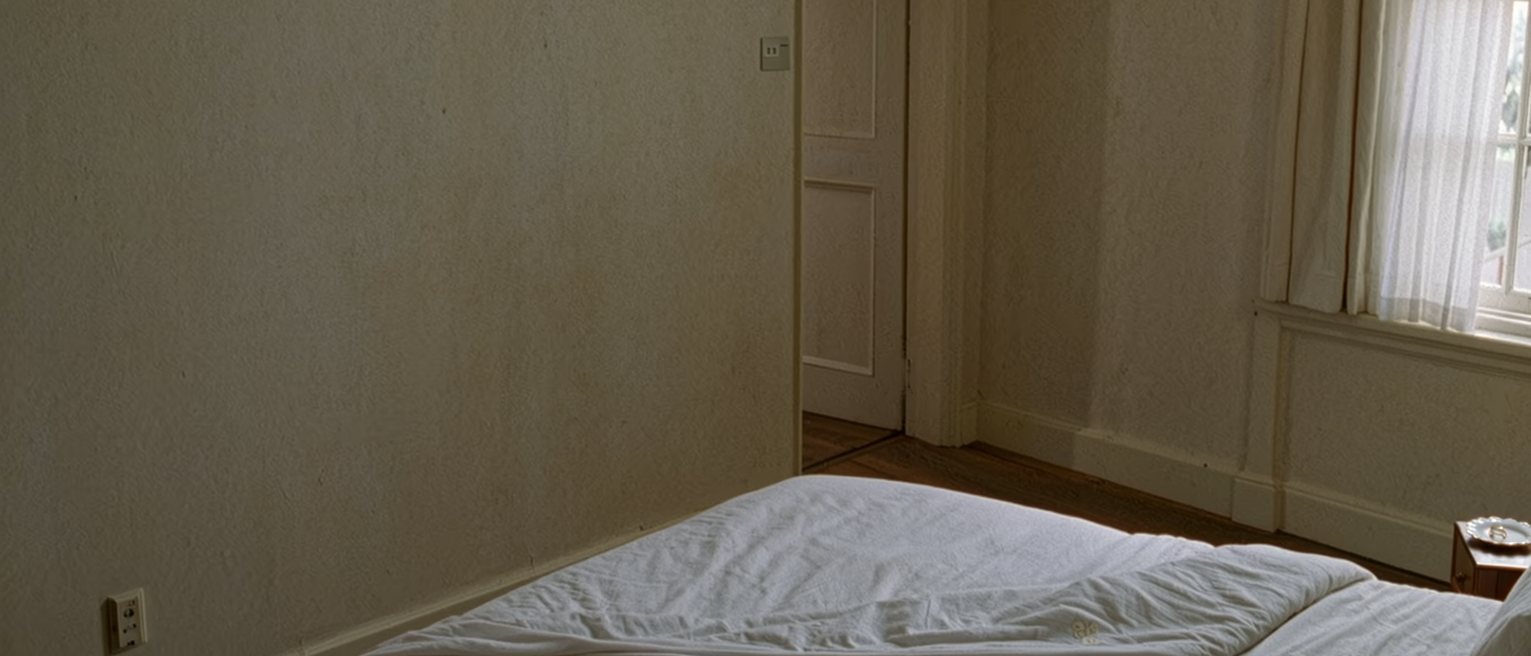 a bedroom with the covers on one side never turned back and a wedding ring in a saucer on the far bedside table