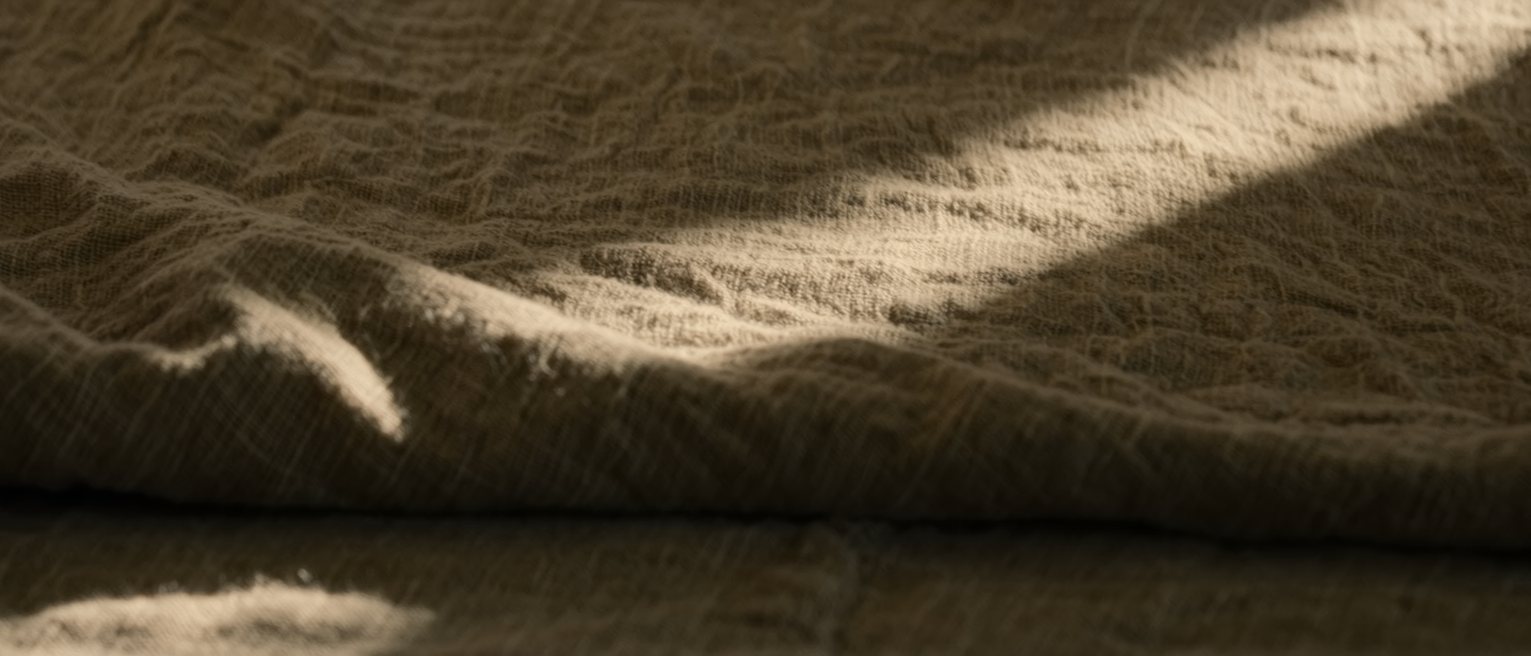 a heavy linen sheet pulled back and left open, the folds holding their shape