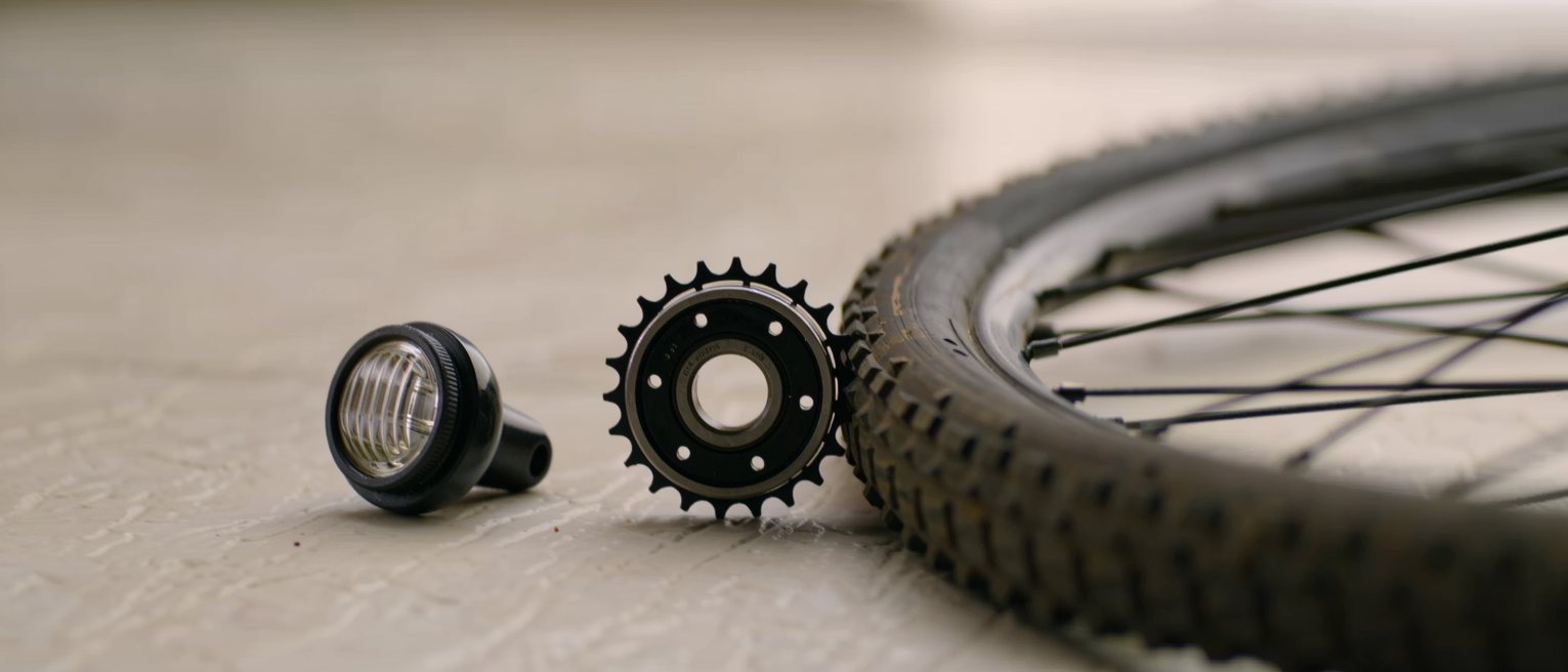 a bicycle dynamo bearing on the tyre with the lamp bracket beside it