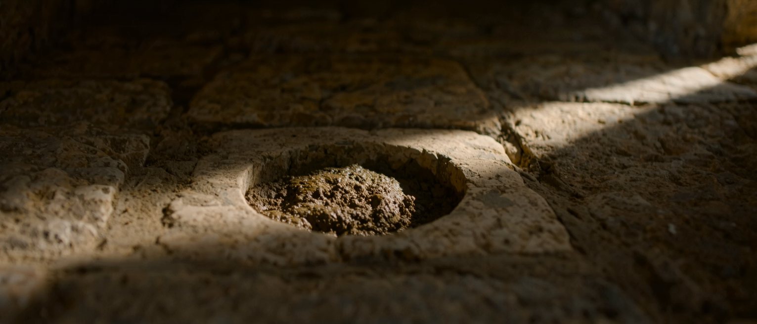 a small hollow cut into an old stone wall, the stone around it worn smooth
