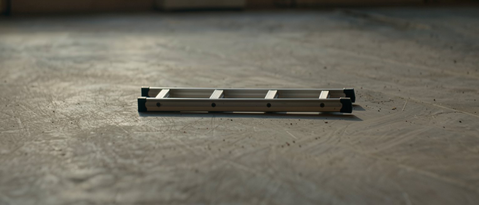 a stepladder standing alone and unopened, its two halves still folded together
