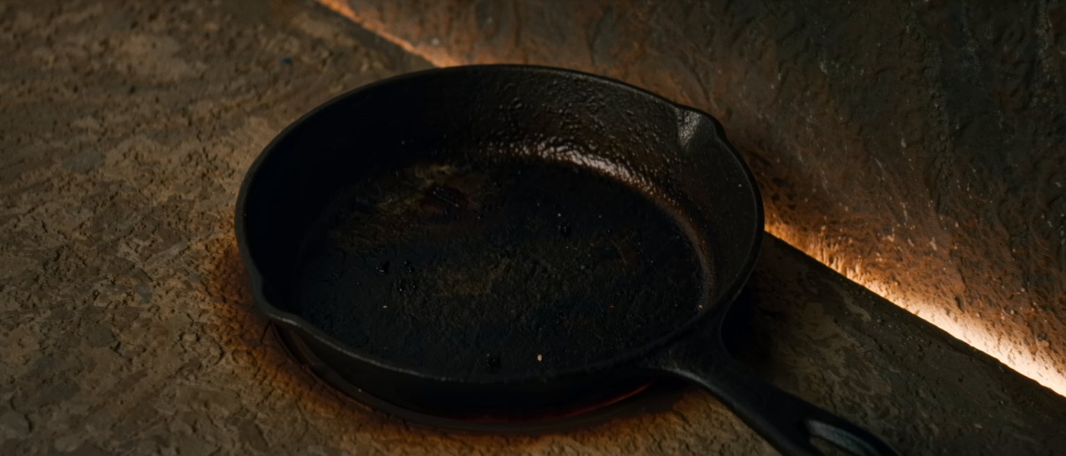 a cast-iron pan with a scorched ring baked onto its base