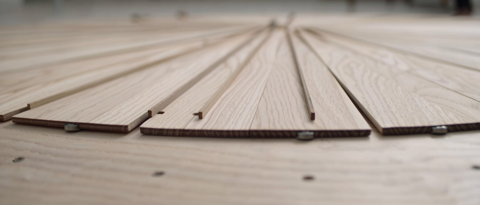 the braced underside of a wooden soundboard, the struts glued out in a fan