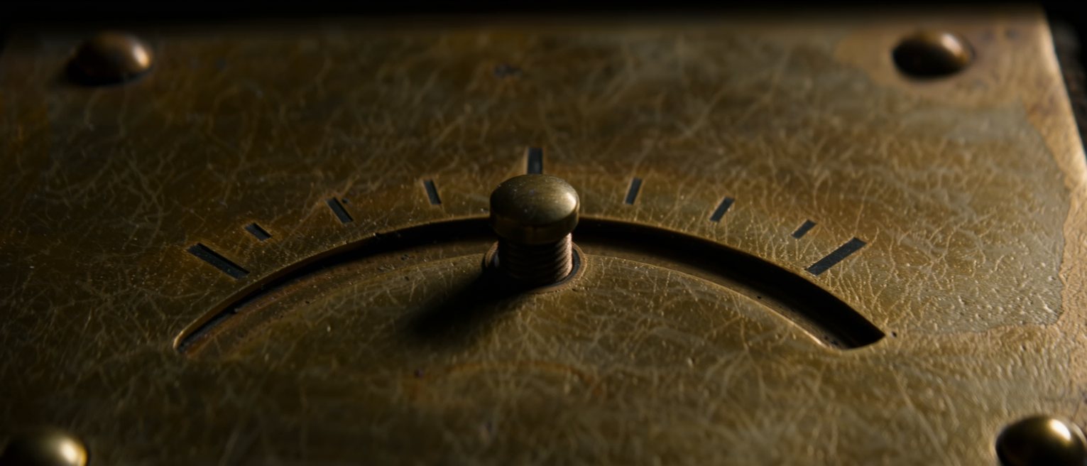a brass lever standing midway in its slotted quadrant, seated at neither end of the slot