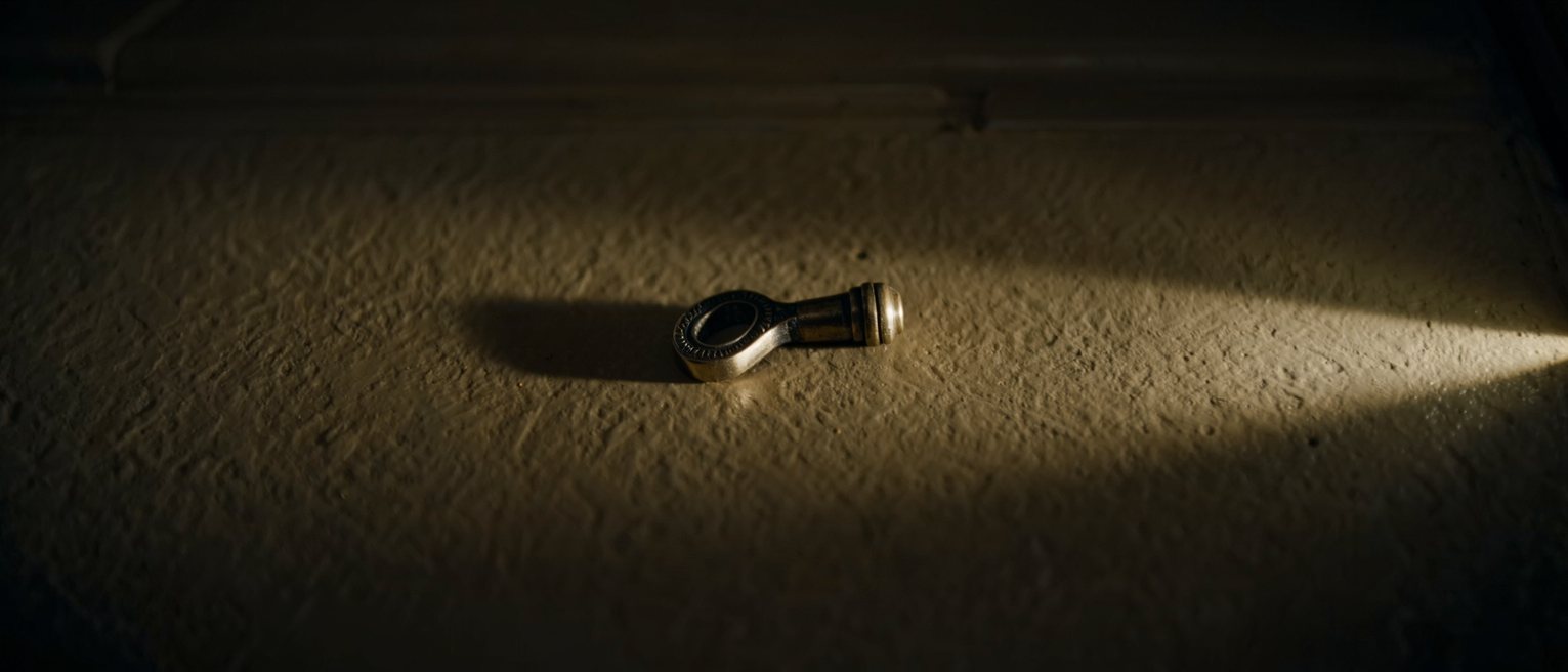 a brass door handle worn down to a paler metal along one side