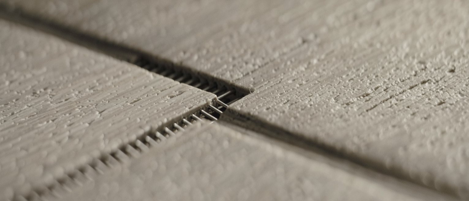 a joiner's dovetail fitted tight, the pins and tails interlocking along the whole edge