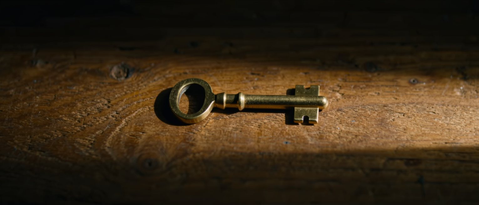 a brass telegraph key on a wooden base, its contacts pressed closed