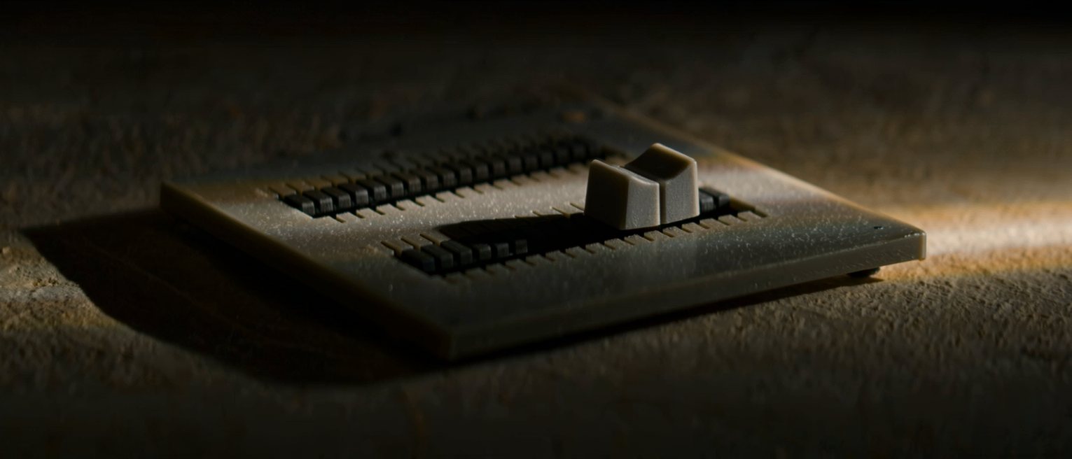 a single mixing desk fader pulled all the way down to its stop and the others left level, the panel beside them smooth and unmarked