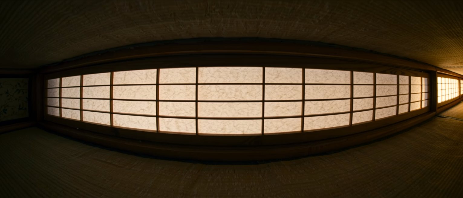 a wooden shoji frame with fresh paper stretched over it, the lattice showing faintly from behind