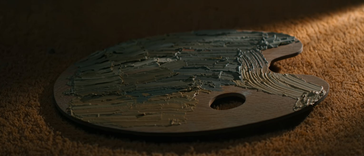 a wooden painter's palette with dried ridges of oil paint across it and no brush laid on it