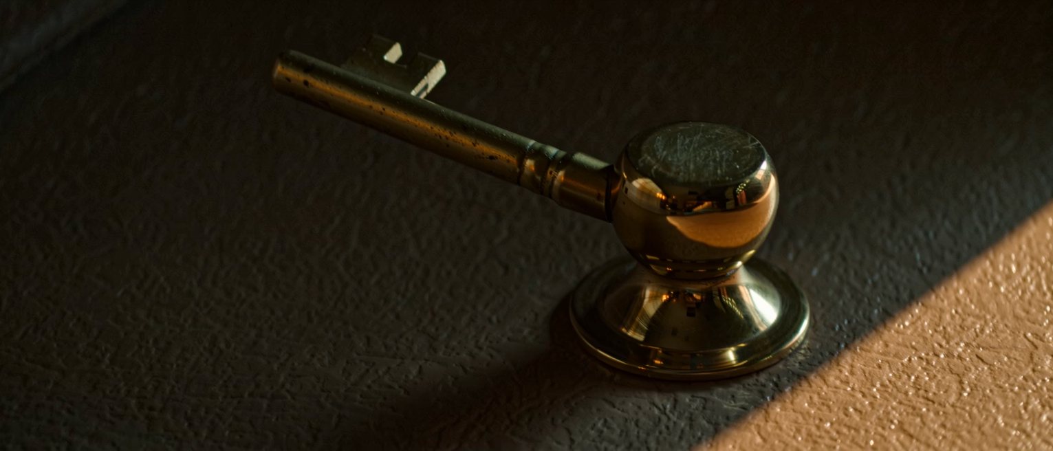 a heavy brass door handle polished bright at the grip and left dull everywhere else