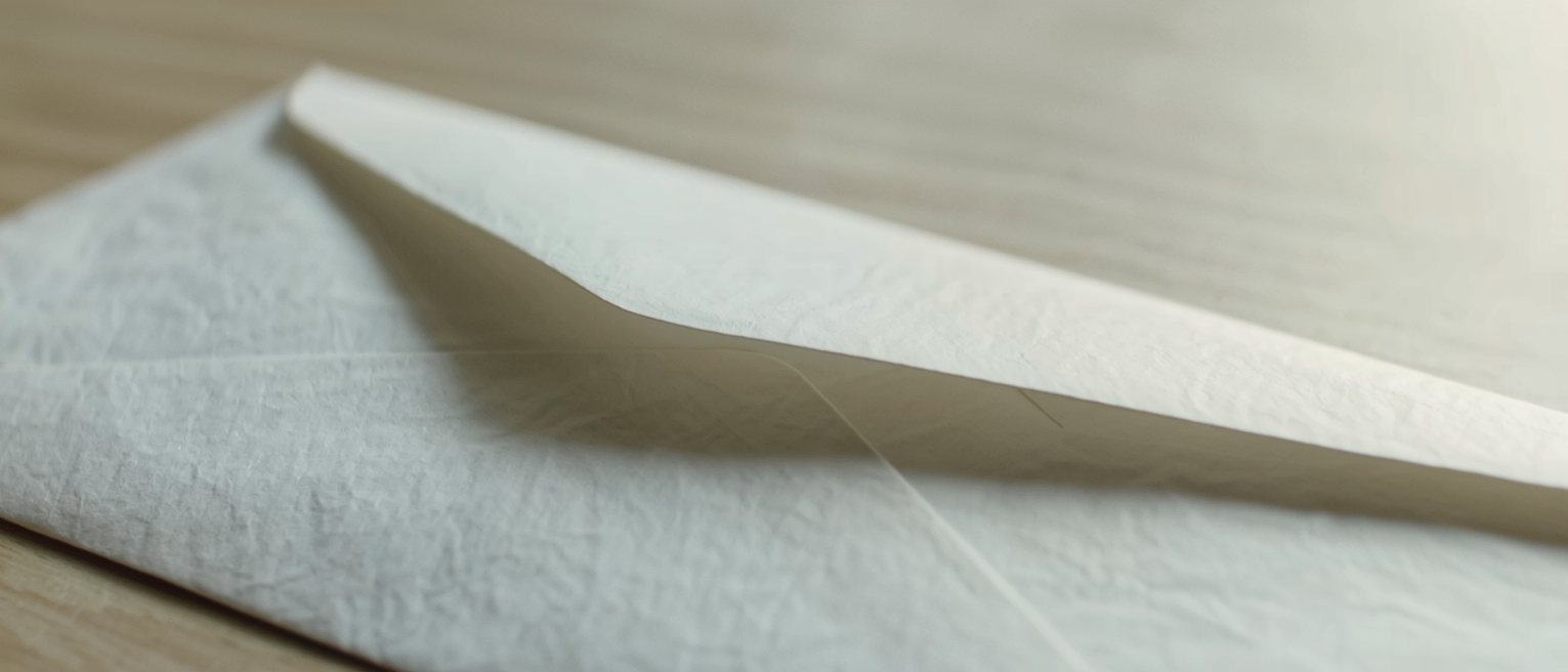 a sealed envelope with no address written on it, lying on a table