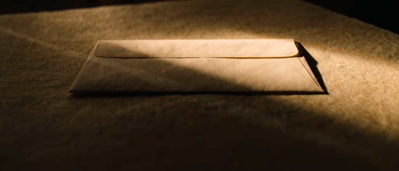 a sealed envelope with no address written on it, lying on a table