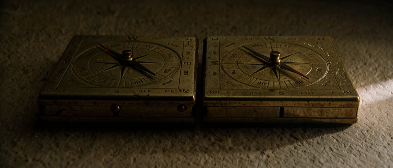 two brass compass cards side by side, each needle settled on a different bearing