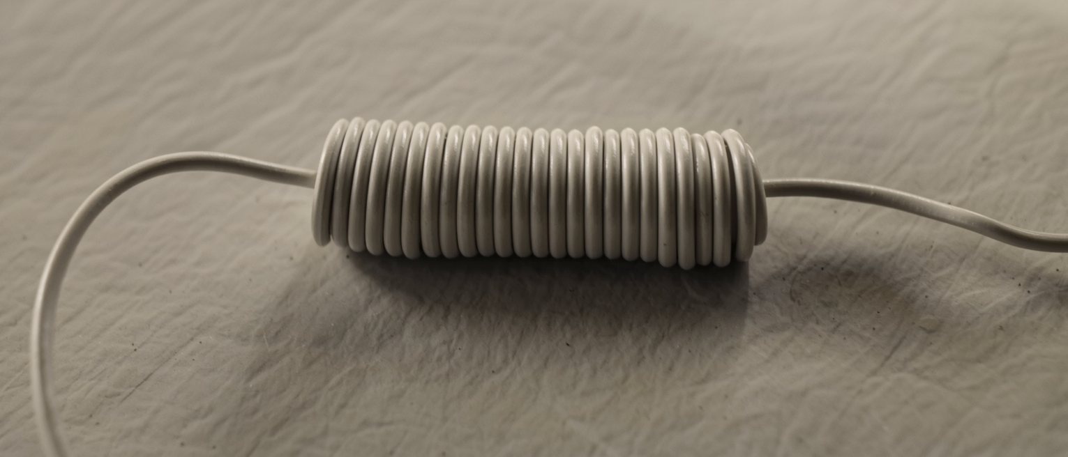 a long telephone cable wound neatly onto its drum, both ends left loose
