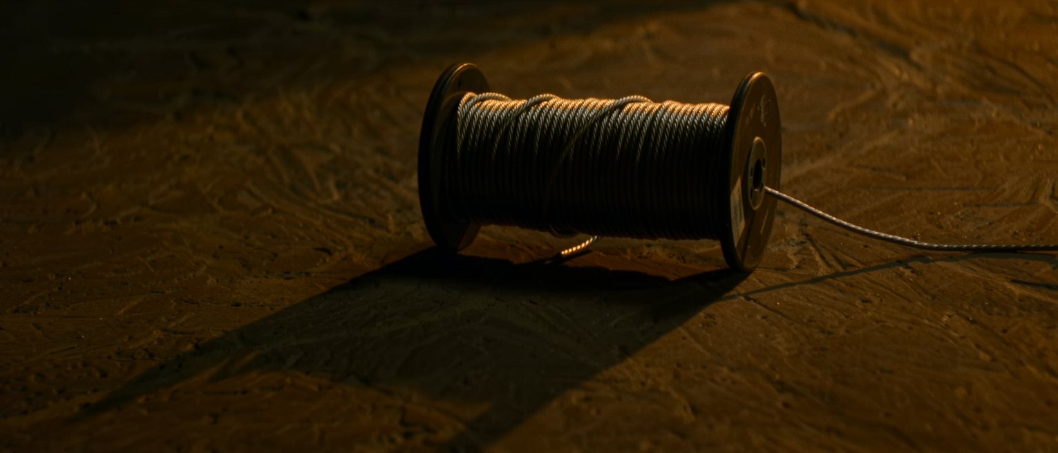 a long telephone cable wound neatly onto its drum, both ends left loose