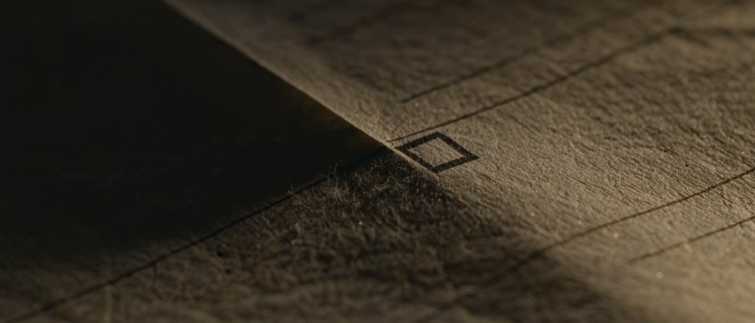 the corner of a printed paper form where a single unmarked tick box stands empty, the sheet slightly cockled