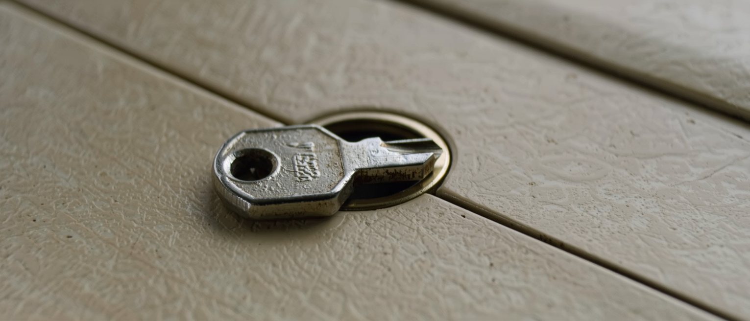 a heavy iron key left in a lock that has been oiled and turns freely