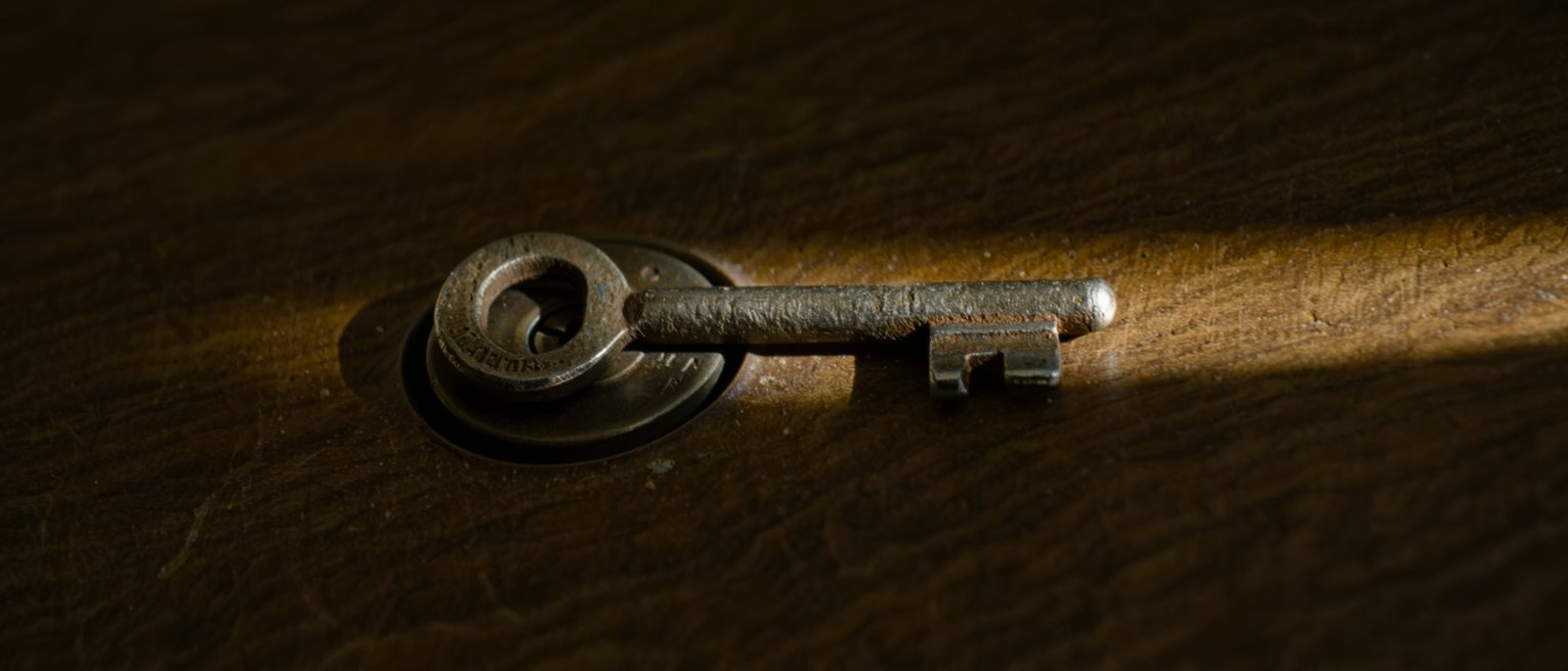 a heavy iron key left in a lock that has been oiled and turns freely