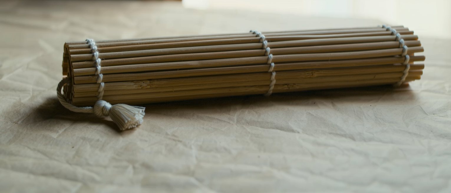 the cord and tassel of a rolled bamboo blind, tied off at the bottom