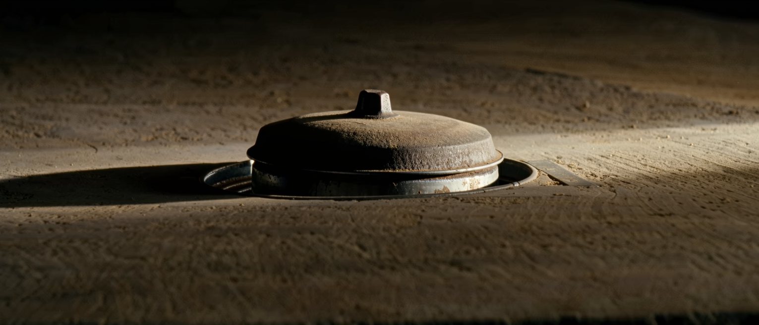 a heavy iron lid seated tight on a cold pot, the rim ground flat to hold
