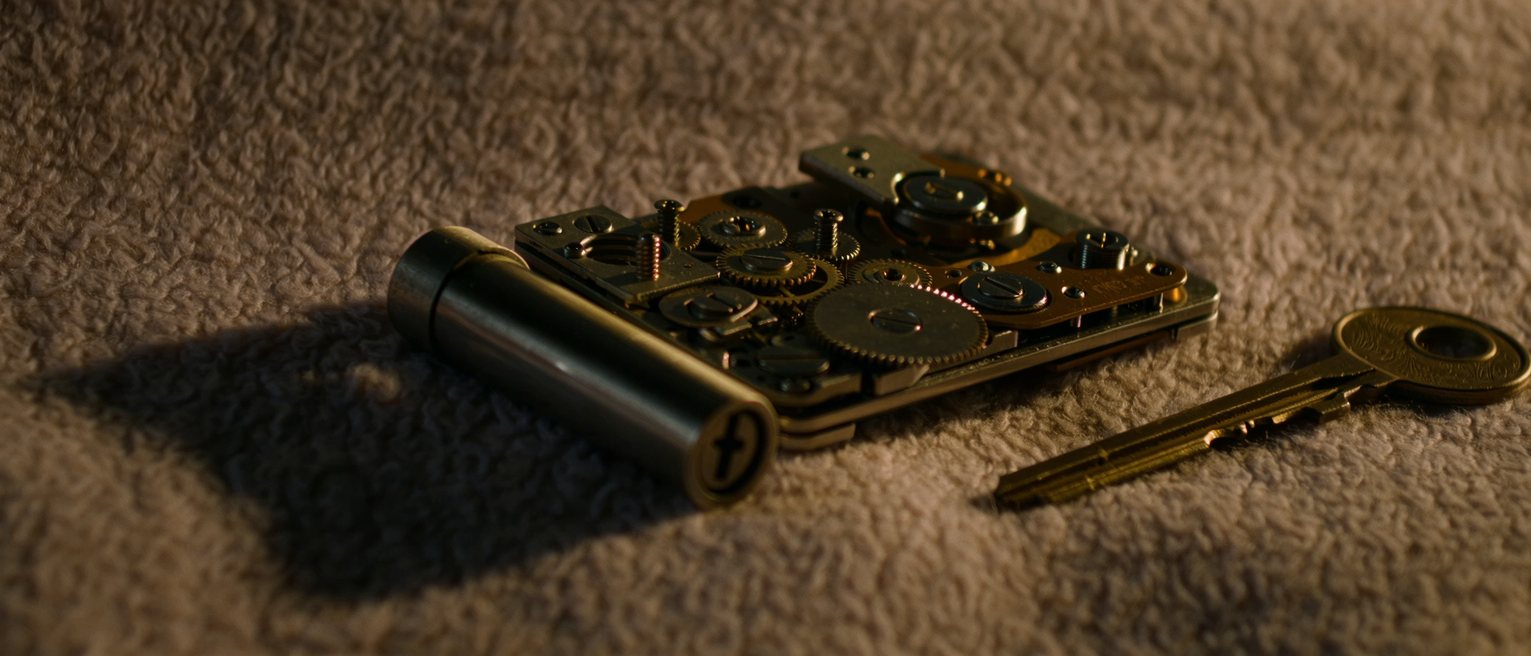 a dismantled lock laid out on a cloth, every part in the order it came out