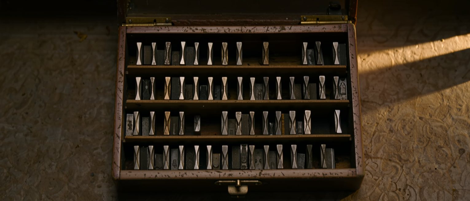 a typesetter's case of sorted metal type with one compartment empty